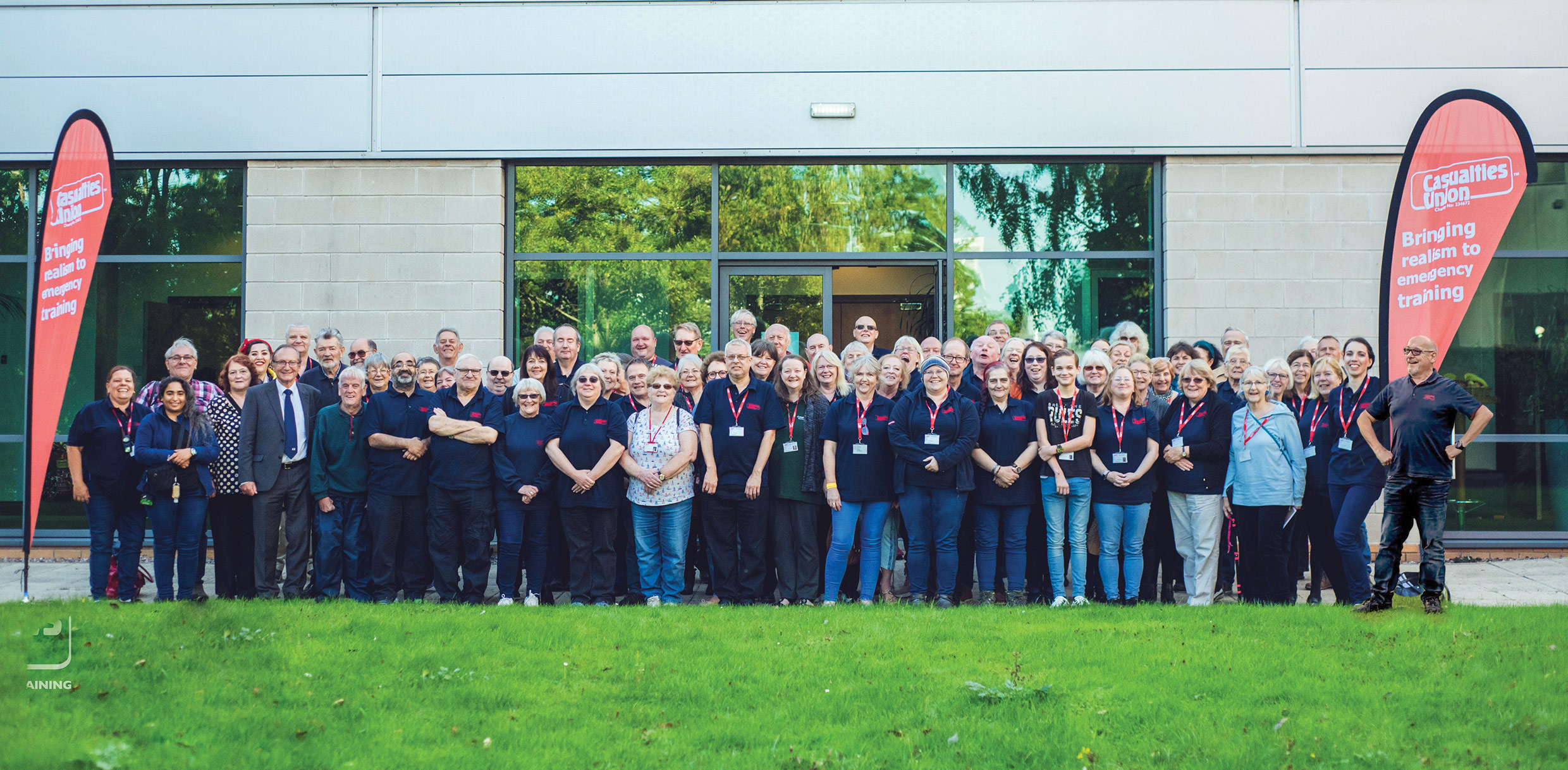 A woman sits by a tree whilst another lady is lying on the floor during a staged vehicle collision incident for emergency services training